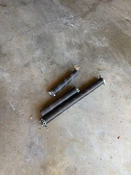Broken torsion spring repair replacement St. Louis MO garage door service