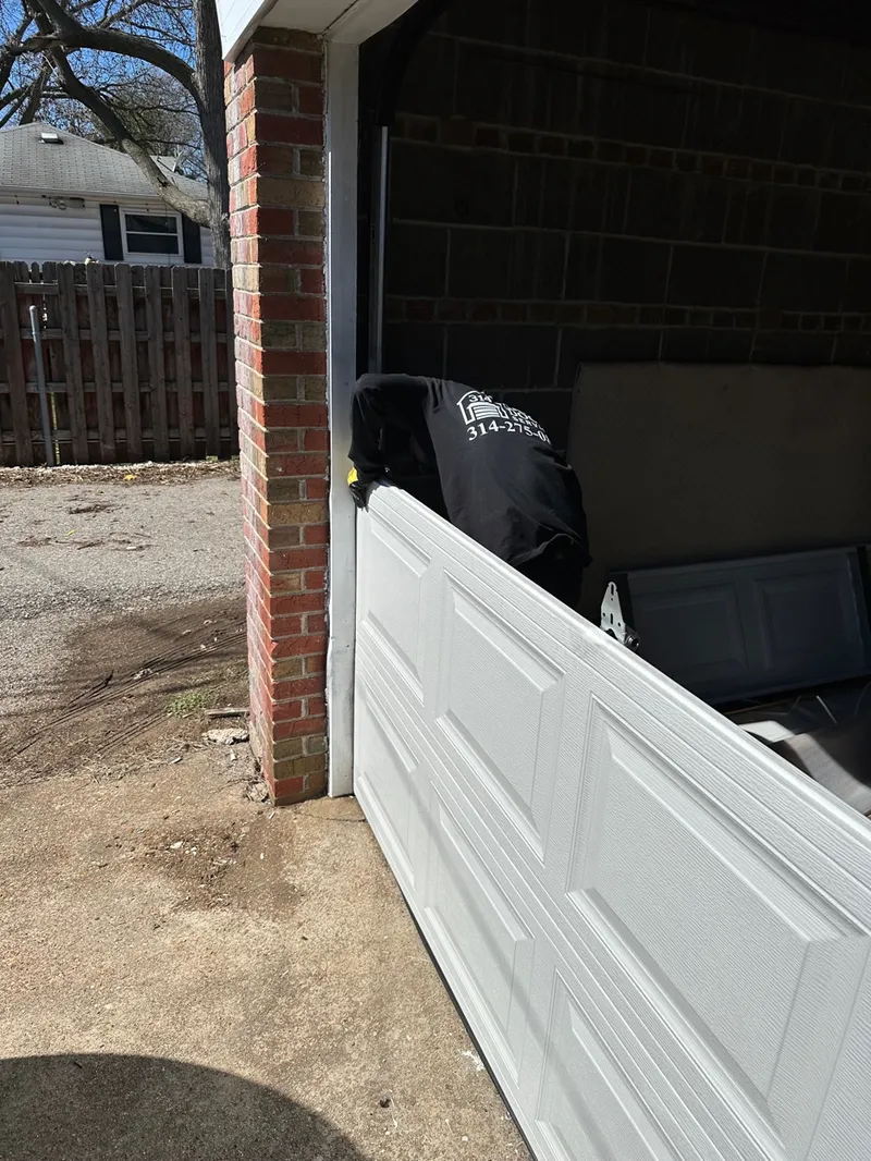 314 Garage Door technician carrying door panel St. Louis MO